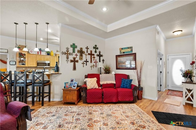 living room featuring light wood-type flooring and ornamental molding