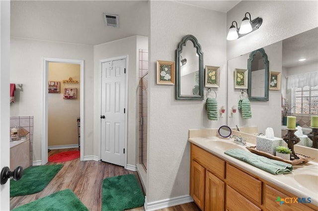 bathroom featuring shower with separate bathtub, vanity, and hardwood / wood-style flooring