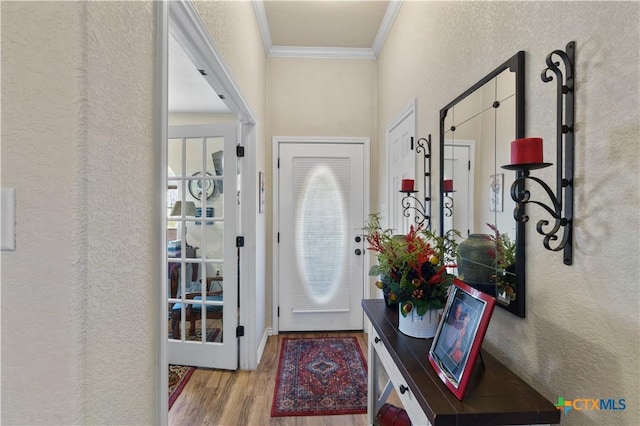 entrance foyer featuring light hardwood / wood-style flooring and crown molding