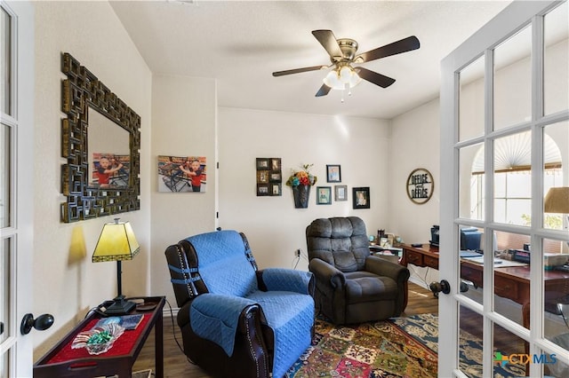 living area featuring hardwood / wood-style flooring and ceiling fan