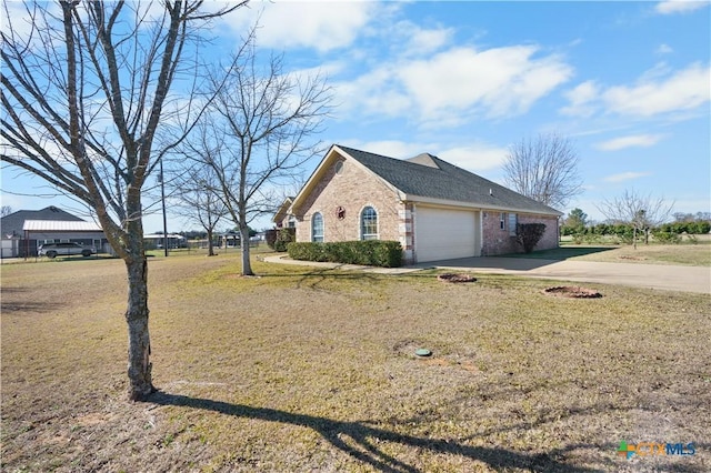 view of home's exterior with a yard and a garage