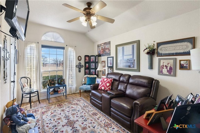 living room with hardwood / wood-style floors, ceiling fan, and lofted ceiling