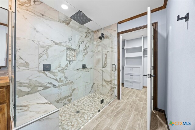 bathroom featuring walk in shower and ornamental molding