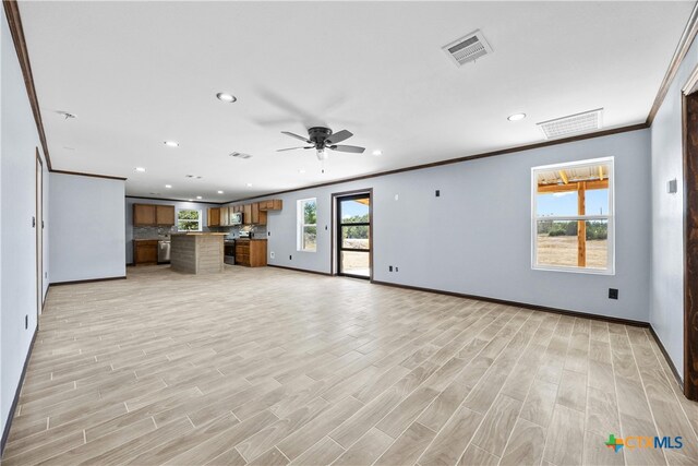 unfurnished living room featuring light wood-type flooring, a wealth of natural light, ceiling fan, and ornamental molding