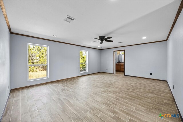 empty room featuring light wood-type flooring, ceiling fan, and crown molding