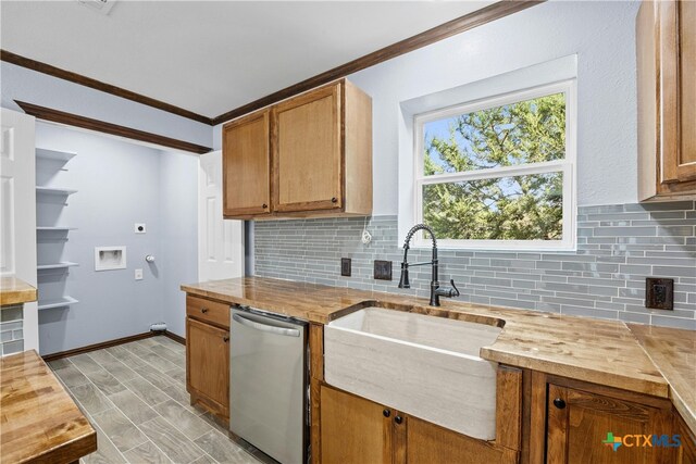 kitchen with dishwasher, wooden counters, sink, and tasteful backsplash