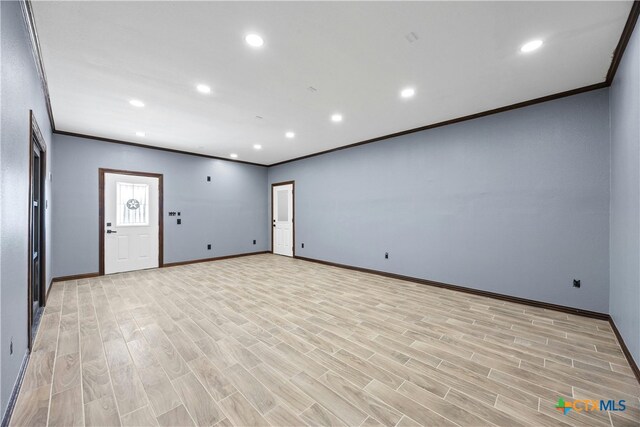 unfurnished living room with light wood-type flooring and crown molding