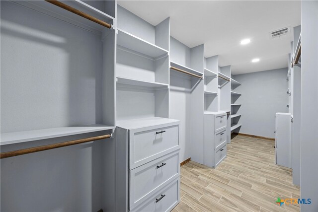 spacious closet with light hardwood / wood-style floors