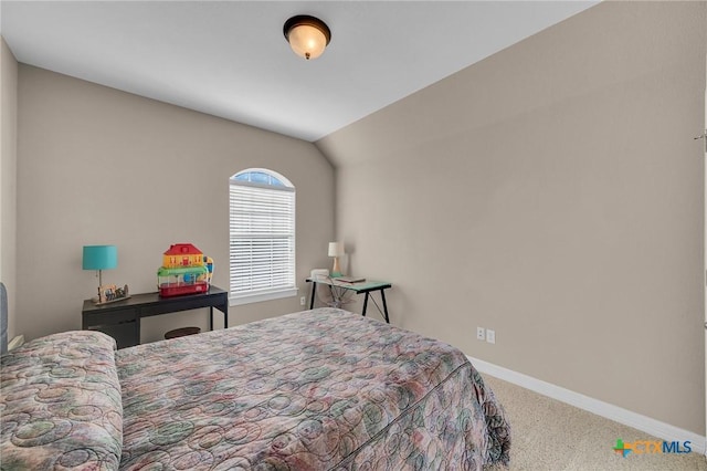 bedroom with vaulted ceiling, carpet, and baseboards