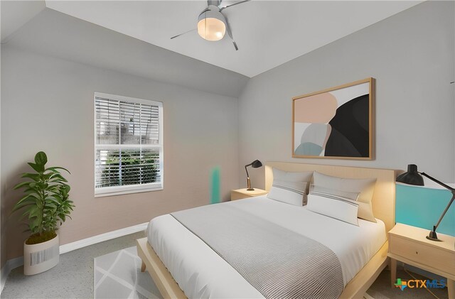 carpeted bedroom featuring baseboards and lofted ceiling