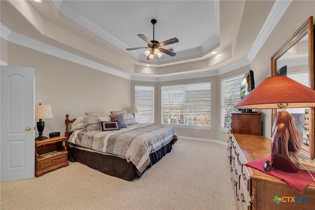 bedroom featuring ceiling fan, baseboards, light colored carpet, a tray ceiling, and ornamental molding