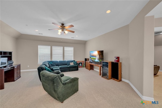 living room with visible vents, ceiling fan, baseboards, lofted ceiling, and light carpet