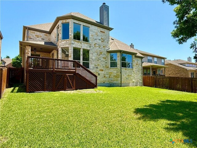 traditional-style home with stone siding, concrete driveway, central AC unit, and a residential view