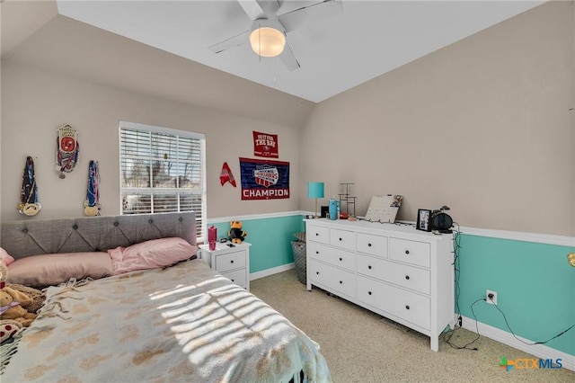 bedroom with ceiling fan, vaulted ceiling, baseboards, and light carpet