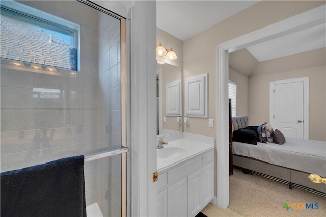 bathroom with a wealth of natural light, a tile shower, and vanity