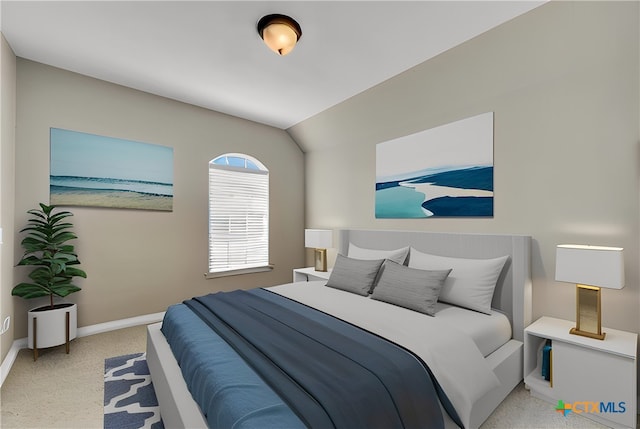 bedroom featuring baseboards and vaulted ceiling