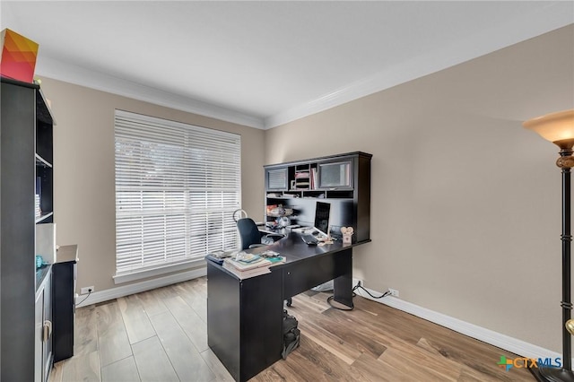 office area featuring light wood-style flooring, baseboards, and ornamental molding