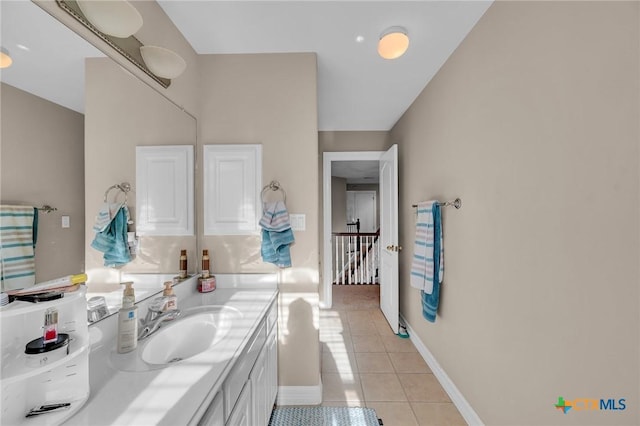 bathroom with tile patterned floors, vanity, and baseboards