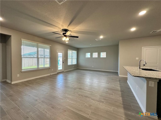 3104 Gryffindor Ln, Killeen, TX 76549 - unfurnished living room with a sink, a ceiling fan, wood finished floors, recessed lighting, and a textured ceiling