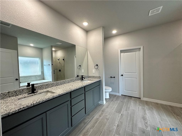 3104 Gryffindor Ln, Killeen, TX 76549 - bathroom with a stall shower, toilet, a garden tub, double vanity, and wood finished floors