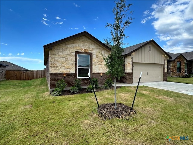 3104 Gryffindor Ln, Killeen, TX 76549 - view of front of house with board and batten siding, concrete driveway, a garage, and brick siding
