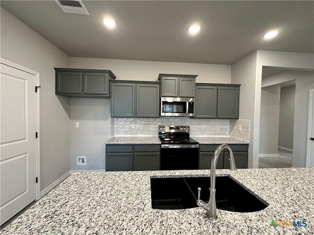 3104 Gryffindor Ln, Killeen, TX 76549 - kitchen featuring stainless steel microwave, range with electric cooktop, backsplash, baseboards, and recessed lighting