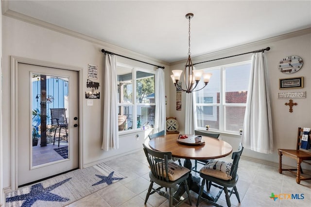 tiled dining space featuring ornamental molding and a chandelier