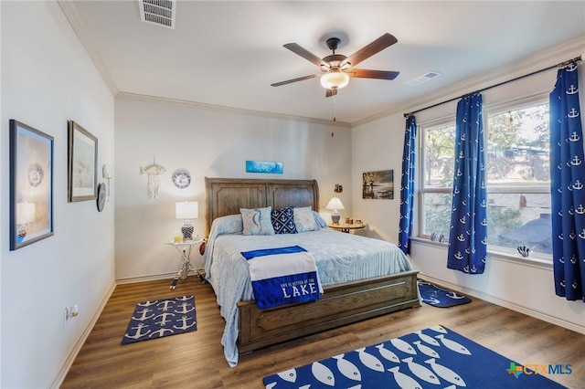 bedroom featuring wood-type flooring, ceiling fan, and ornamental molding