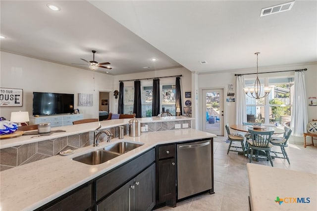 kitchen featuring sink, stainless steel dishwasher, decorative light fixtures, light tile patterned flooring, and ceiling fan with notable chandelier