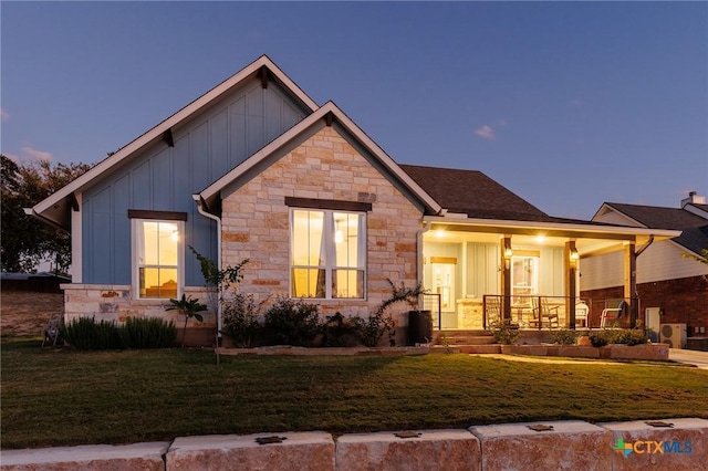 craftsman-style home featuring covered porch and a yard