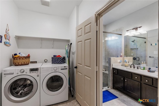 washroom with independent washer and dryer and sink