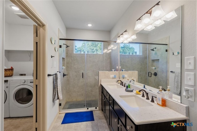 bathroom featuring vanity, washer / clothes dryer, tile patterned floors, and an enclosed shower