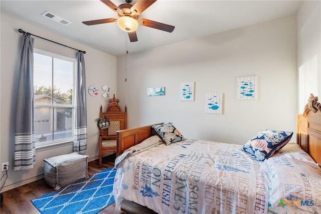 bedroom with ceiling fan and dark hardwood / wood-style floors