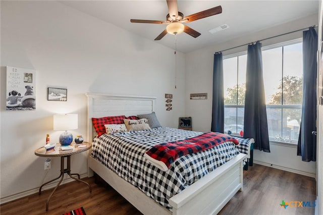 bedroom featuring ceiling fan and dark wood-type flooring