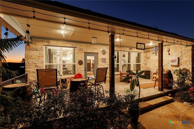 view of patio terrace at dusk