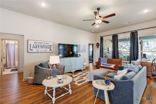 living room with crown molding, ceiling fan, and dark hardwood / wood-style floors