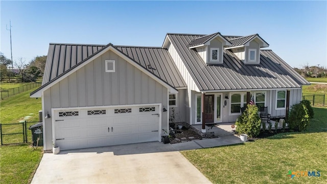 view of front of property featuring board and batten siding, concrete driveway, an attached garage, and fence