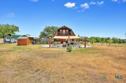 view of yard featuring a rural view and a storage unit