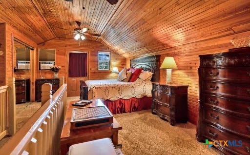 bedroom featuring wood walls, vaulted ceiling, light colored carpet, and wooden ceiling