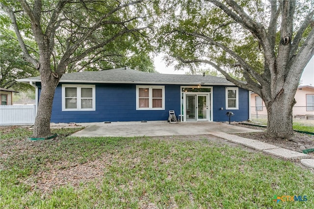 back of house with a lawn and a patio area