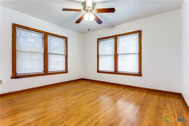 spare room featuring light hardwood / wood-style floors and ceiling fan