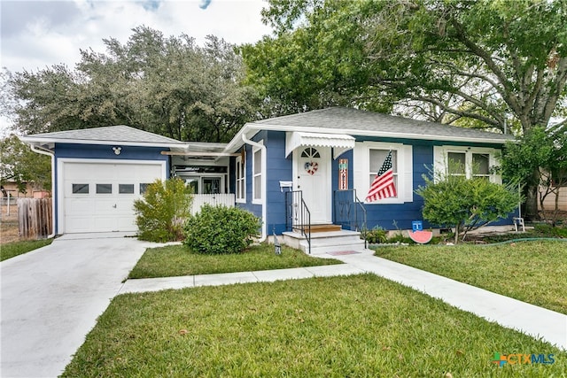 view of front of home featuring a garage and a front lawn