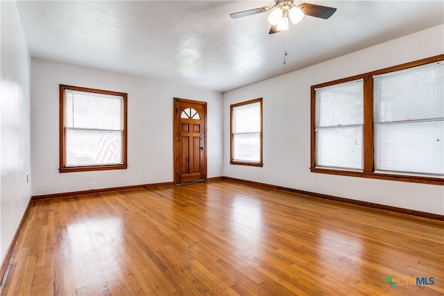 entryway with ceiling fan and wood-type flooring