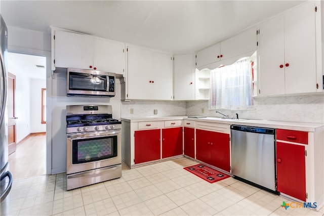 kitchen with white cabinetry, appliances with stainless steel finishes, sink, and tasteful backsplash