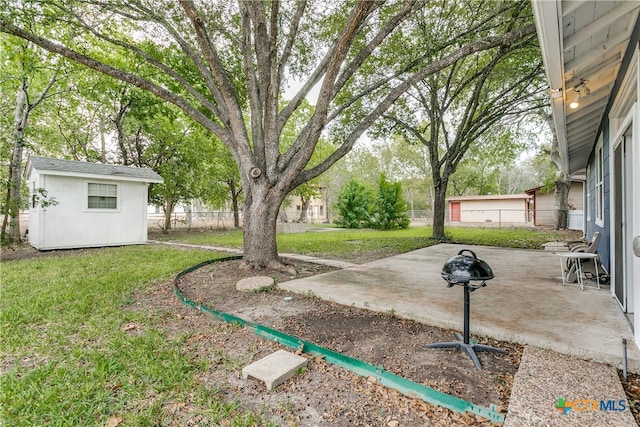 view of yard featuring an outdoor structure and a patio