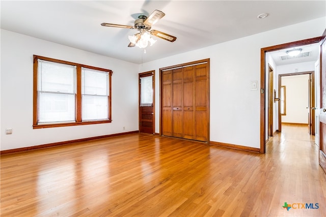 unfurnished bedroom featuring light hardwood / wood-style flooring, ceiling fan, and a closet