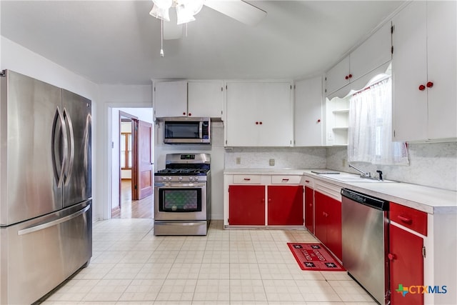 kitchen with appliances with stainless steel finishes, sink, ceiling fan, and plenty of natural light