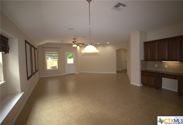 2005 Granite Springs Rd, Leander, TX 78641 - unfurnished living room featuring arched walkways, ceiling fan, baseboards, recessed lighting, and lofted ceiling