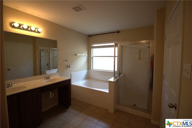 2005 Granite Springs Rd, Leander, TX 78641 - bathroom with a stall shower, a garden tub, tile patterned floors, and double vanity