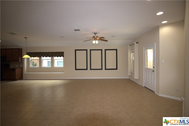 unfurnished living room with ceiling fan